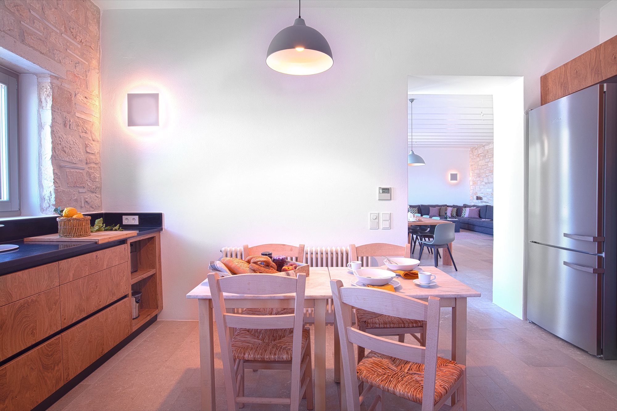 The kitchen breakfast table, open to the dining room