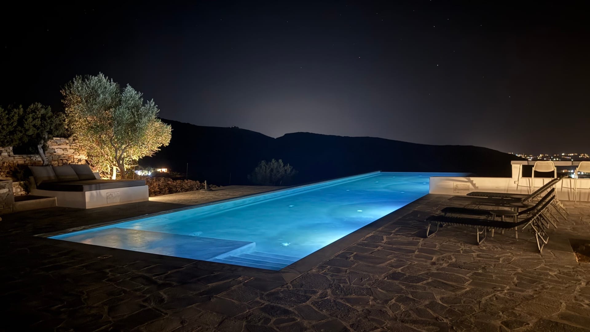 The infinity pool at night under a clear starry sky