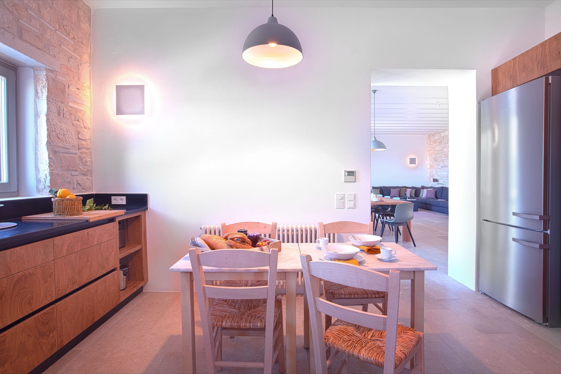 The kitchen breakfast table, open to the dining room